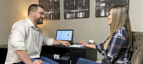 Chiropractor Berkley MI Nick Novakoski Reviewing Paperwork