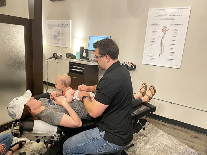 Chiropractor Berkley MI Nick Novakoski Adjusting Mom and Baby