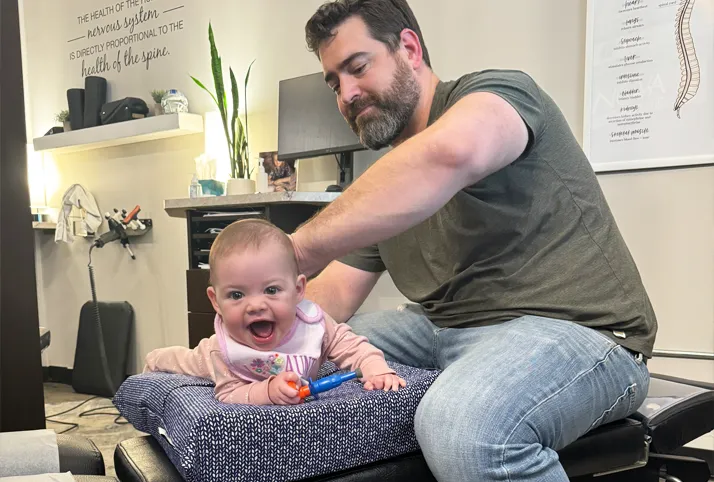 Chiropractor Royal Oak MI Nick Novakoski Adjusting Infant