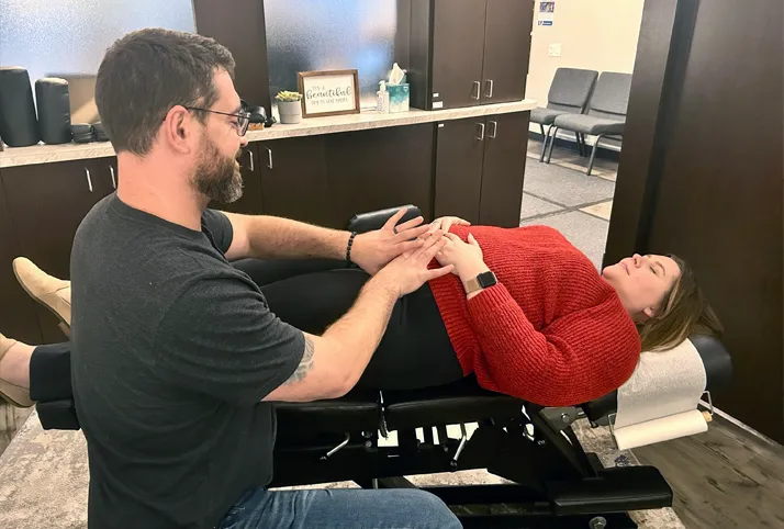 Chiropractor Royal Oak MI Nick Novakoski Adjusting Pregnant Mother