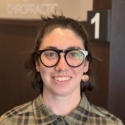 Emma smiling at camera with glasses